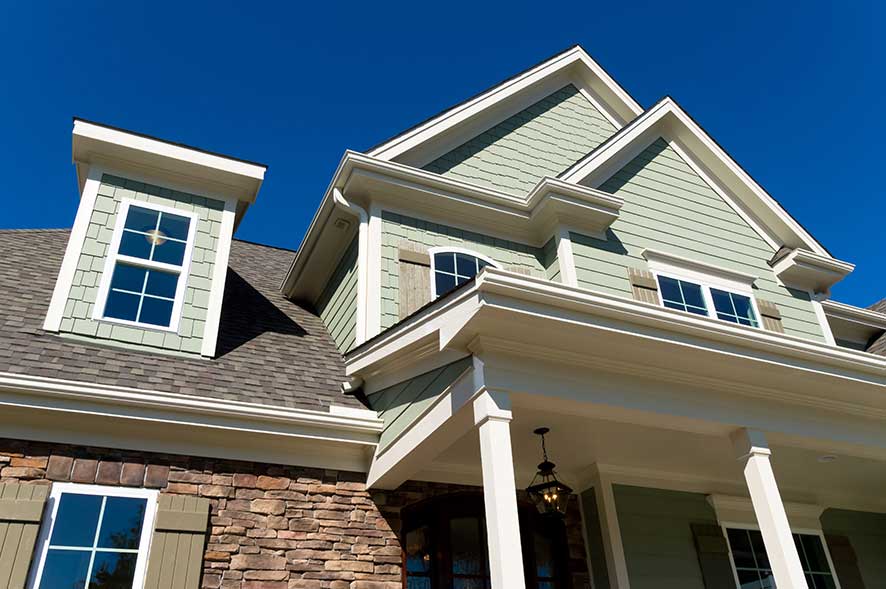 Looking up at the front, exterior of a new home.