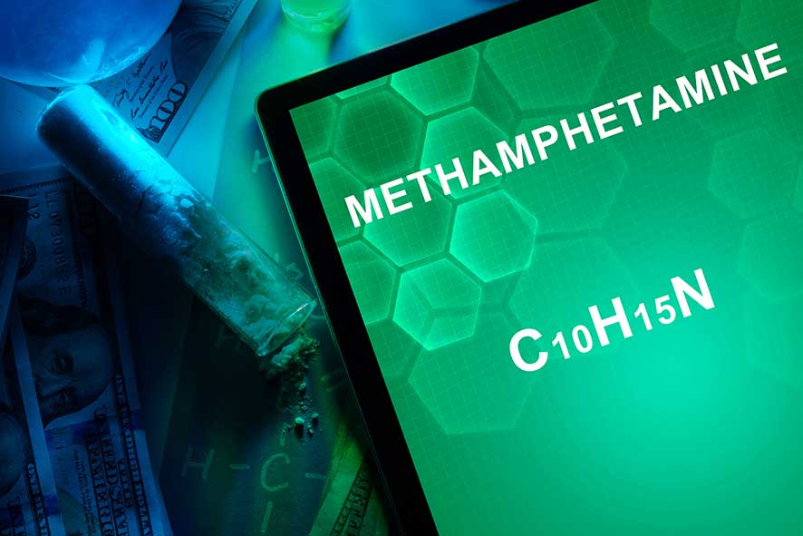 Tablet screen displaying the word "Methamphetamine" on a green background.