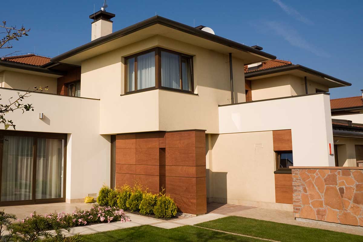 Single family, modern style yellow house with blue sky