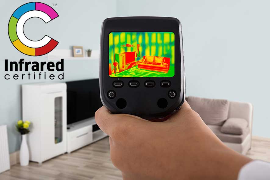 Person Hand Using Infrared Thermal Camera In Living Room. Infrared Certified logo in the corner of image.